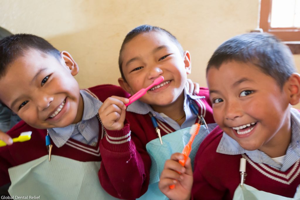 three boys with toothbrushes
