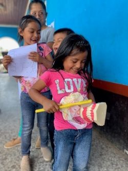 little girls smiling and laughing at teeth brushing